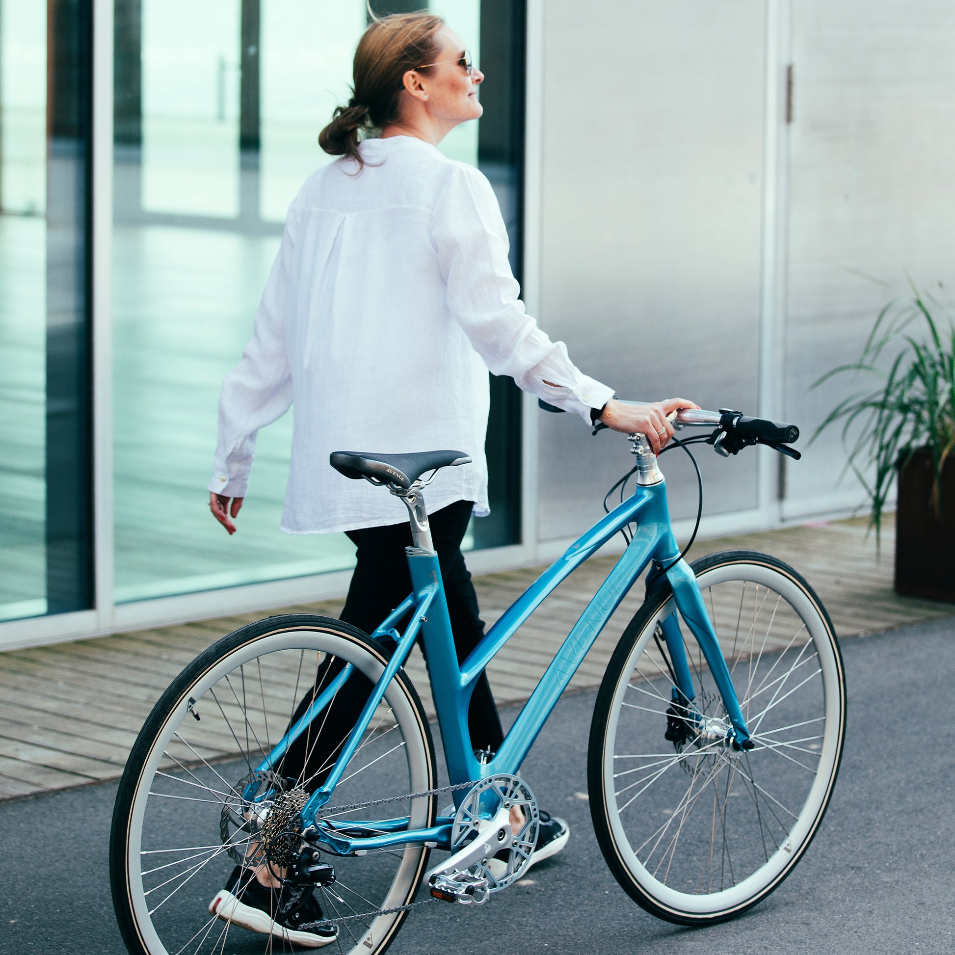 Blå cykel med upprätt ram, skivbroms i framhjulet och sadel